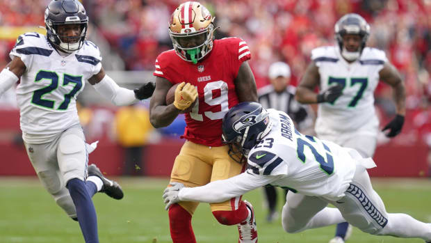 Jan 14, 2023; Santa Clara, California, USA; San Francisco 49ers wide receiver Deebo Samuel (19) is defended by Seattle Seahawks safety Johnathan Abram (23) and cornerback Tariq Woolen (27) in the third quarter of a wild card game at Levi’s Stadium. Mandatory Credit: Cary Edmondson-USA TODAY Sports